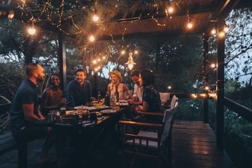A backyard party lit by candlelight