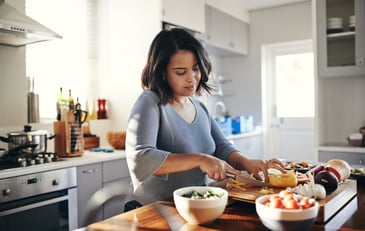 A woman cooking a large meal in the kitchen