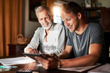 father and son going over their finances for college