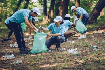 group gathered to pick up trash in a park