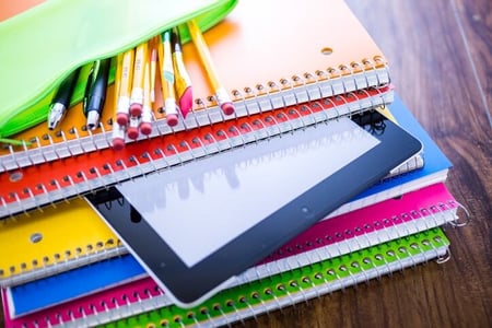notebooks and ipad on a desk