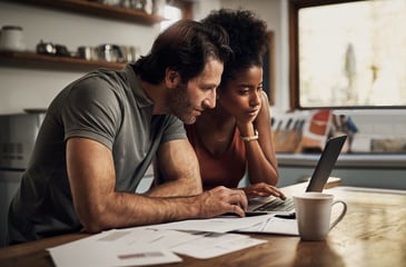 A couple managing their finances on their computer