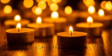 Candles lit in a dark space