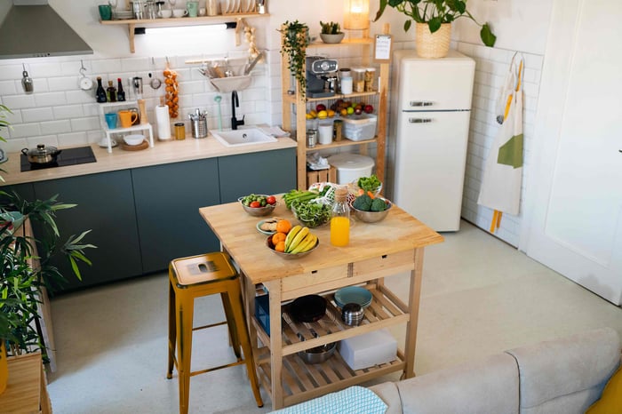 A kitchen with many different furniture solutions like wooden islands