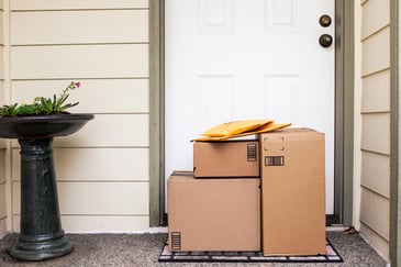 A pile of cardboard boxes sitting on a porch