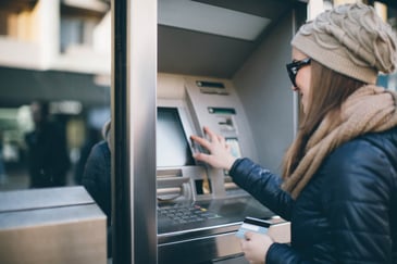 woman-using-atm-machine
