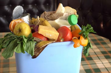 trash can overflowing with food waste