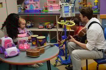 A music therapist works with a young child.