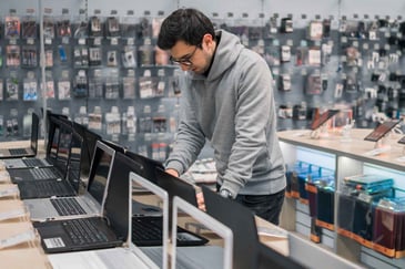 a young man shopping for a computer