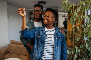 couple-holding-keys-in-their-new-home