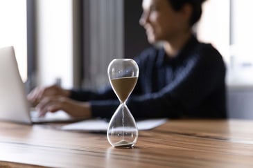 woman-at-desk-with-hour-glass