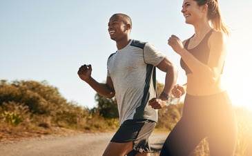 a couple running on a trail