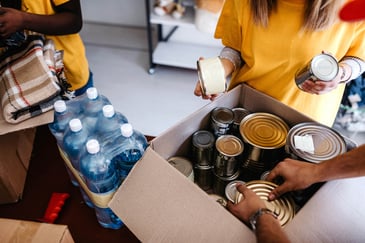 cans-and-food-perishables-being-placed-in-a-box