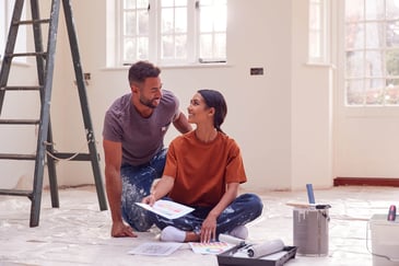 couple-sitting-in-house-painting