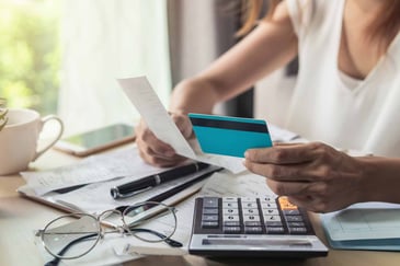 person-paying-bills-with-credit-card