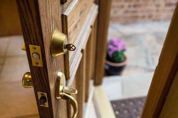 Open front door with a key in the lock