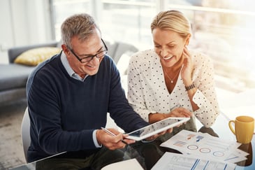 Couple looking at their finances on iPad