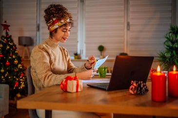 woman-purchasing-christmas-gifts-online