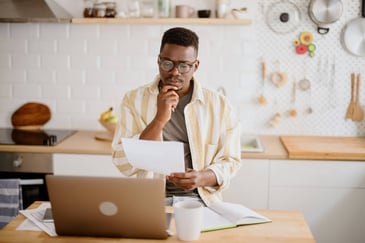 man-looking-over-his-bills-with-his-laptop