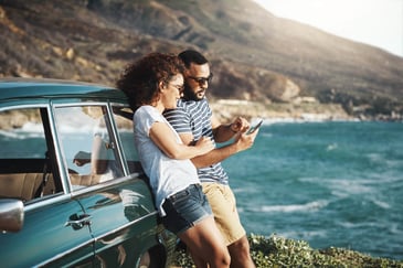 couple-on-vacation-looking-at-their-phone