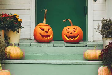 carved-pumpkins-sitting-on-a-porch-outside