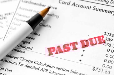 pen sitting on a passed due bill