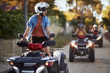 Several friends ride together on ATVs