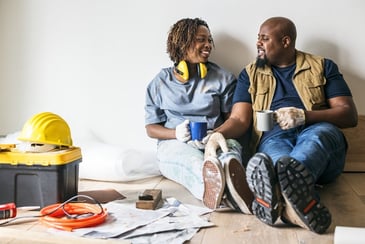 A couple takes a break from completing home renovations